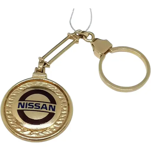 Золотой брелок NISSAN. 5221550