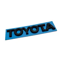 Емблема напис TOYOTA чорна 120х20 мм пластик (на скотчі)
