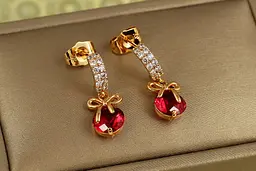 Сережки гвоздики Xuping Jewelry Бантик з малиновим каменем 2,3 см золотисті