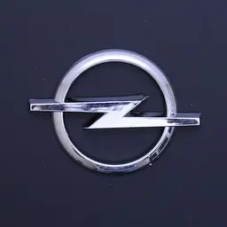 Емблема для Opel 80 x 60 мм пластикова Xром скотч