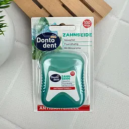 Зубна нитка Dontodent Antibakteriell антибактеріальна (вощена з фтором, м'ятний смак), 100 м