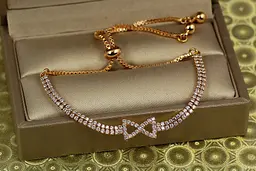 Браслет Xuping Jewelry регульований дві доріжки з бантиком на бігунку золотистий