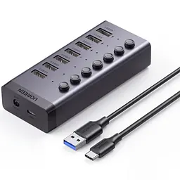 USB-хаб із заряджанням UGREEN CM481 до USB-A комп’ютера через вхід USB-C 7 портів USB-A 3.0 до 5 Гбіт/с BC 1.2 на портах 4–7 сумарно 5 В до 3,5 А живлення DC від комплектного адаптера окремі вимикачі й індикатори портів захист від зворотного й надмірного струму та короткого замикання Windows Mac OS Linux без драйверів сумісний зі старішою USB-периферією знімний кабель USB-A ↔ USB-C 1 м у комплекті алюмінієвий корпус сірий із чорними торцями (90307)