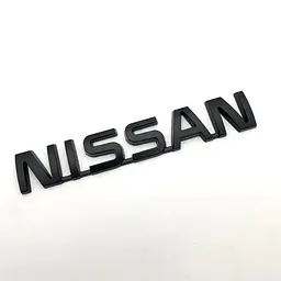 Емблема напис Nissan Чорна 122х22 мм на скотчі (Завод)